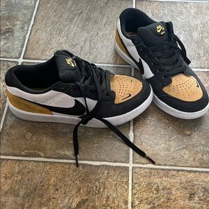 Nike Black and Gold Sneakers (fit a womens 7.5)
